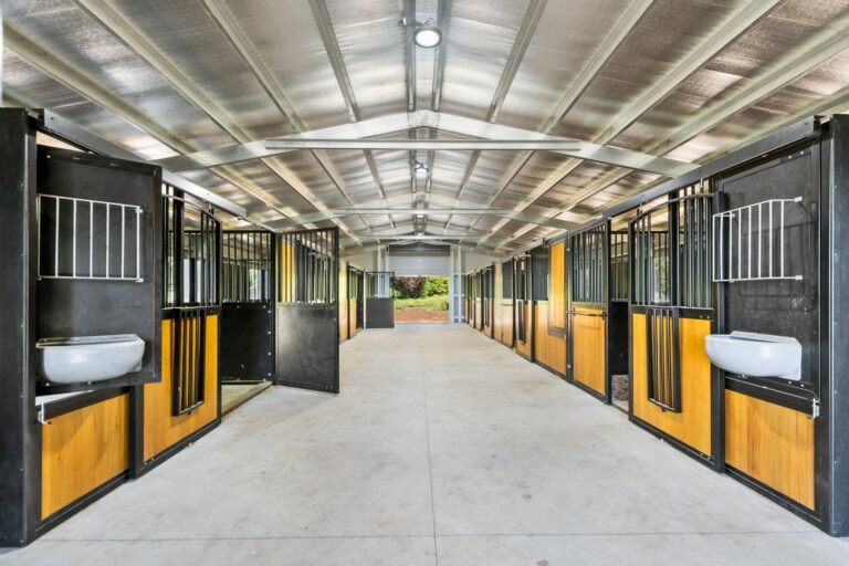 Horse stables with hardwood infill and powder coated frame in black with rotating feeder section