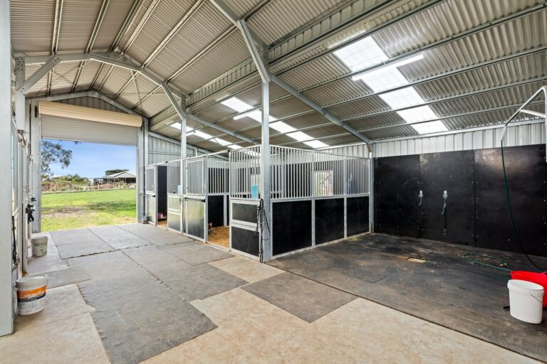 Equibaord stables in American style barn with wash bay