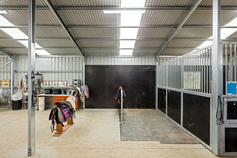 Equibaord stables in American style barn with tie up rail