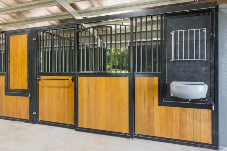 Horse stables with hardwood infill and powder coated frame in black and rotating feeder section