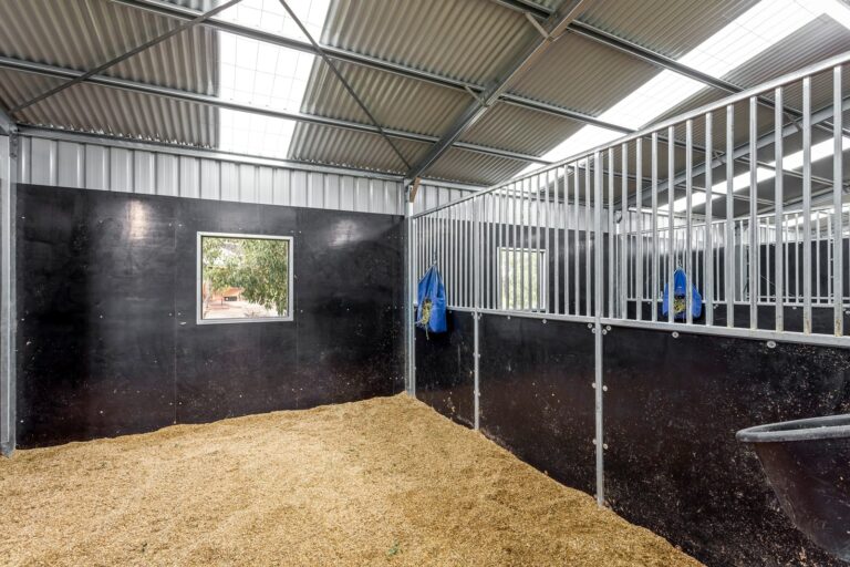 Equibaord stables in American style barn with shutters