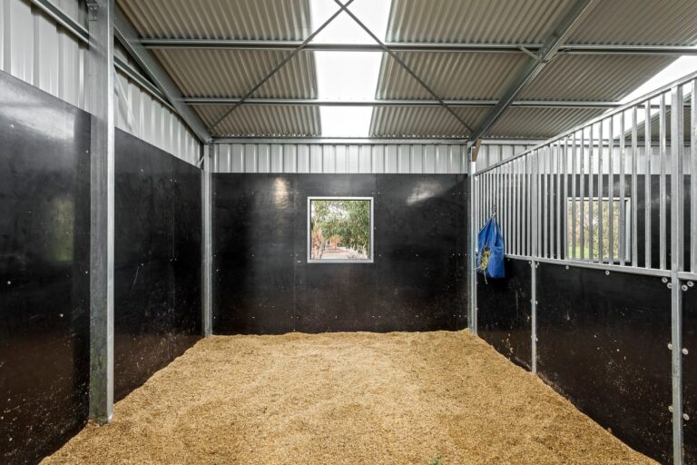 Equibaord stables in American style barn with shutters