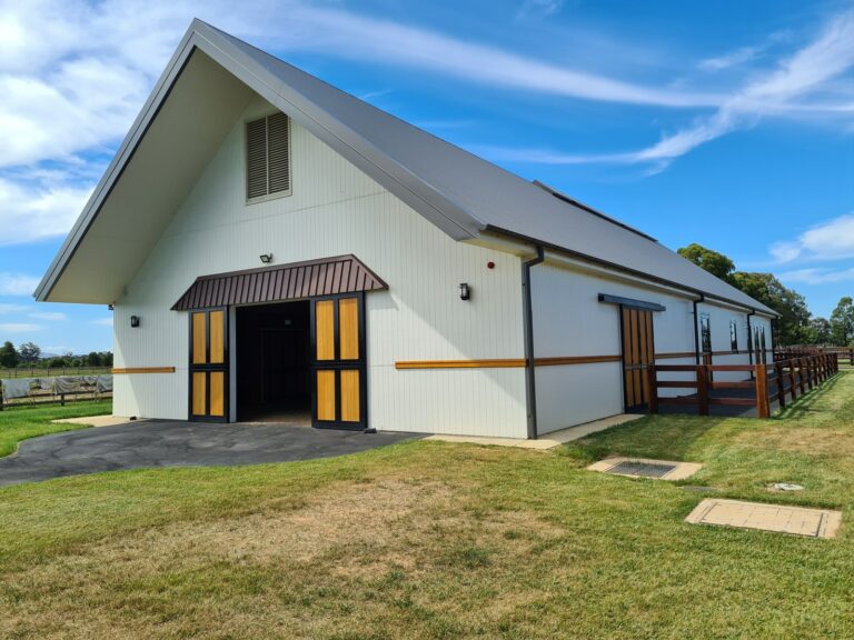Yulong horse barn with champion hardwood barn doors and black powder coating